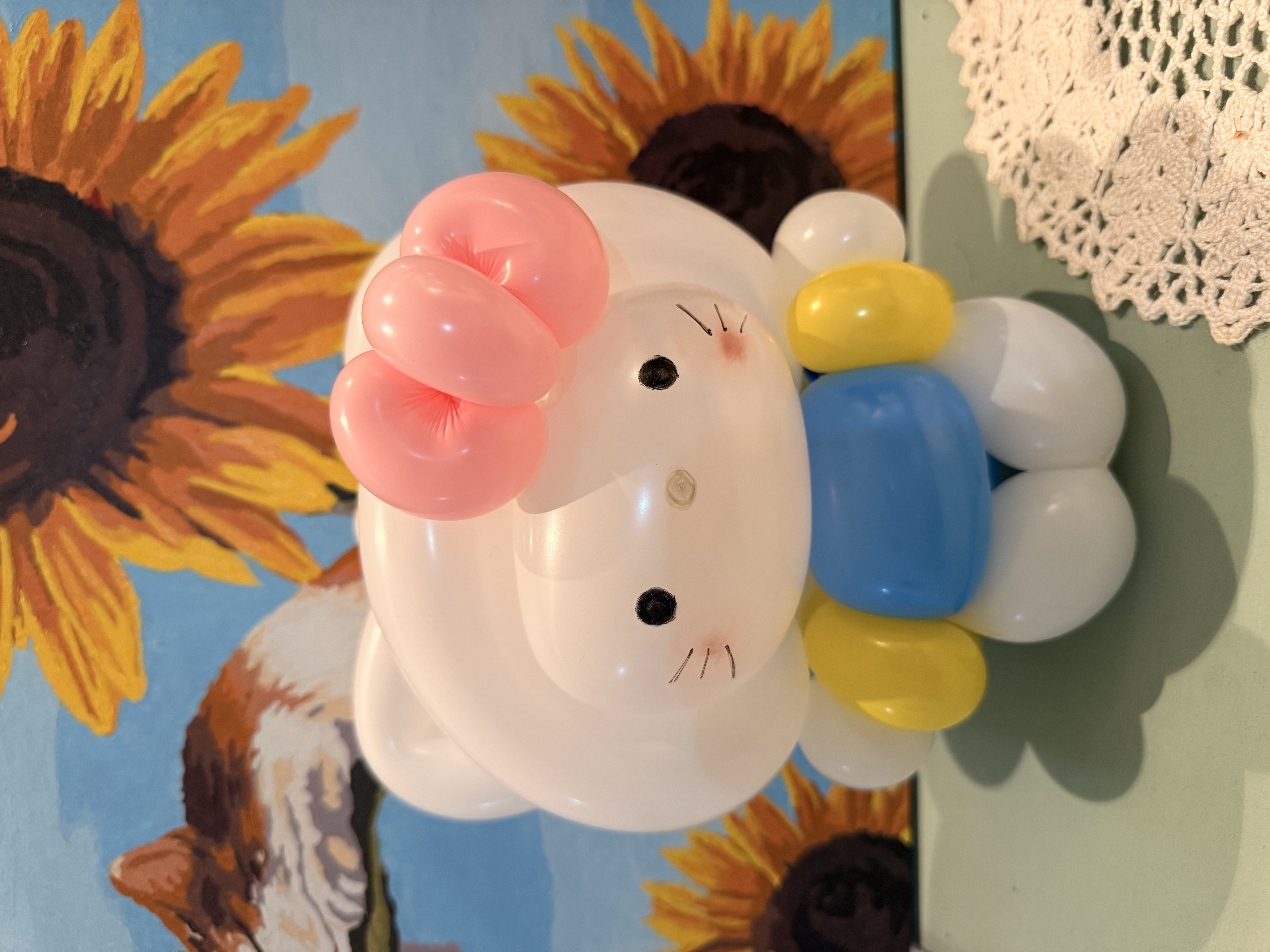 Hello Kitty balloon art with sunflower painting background