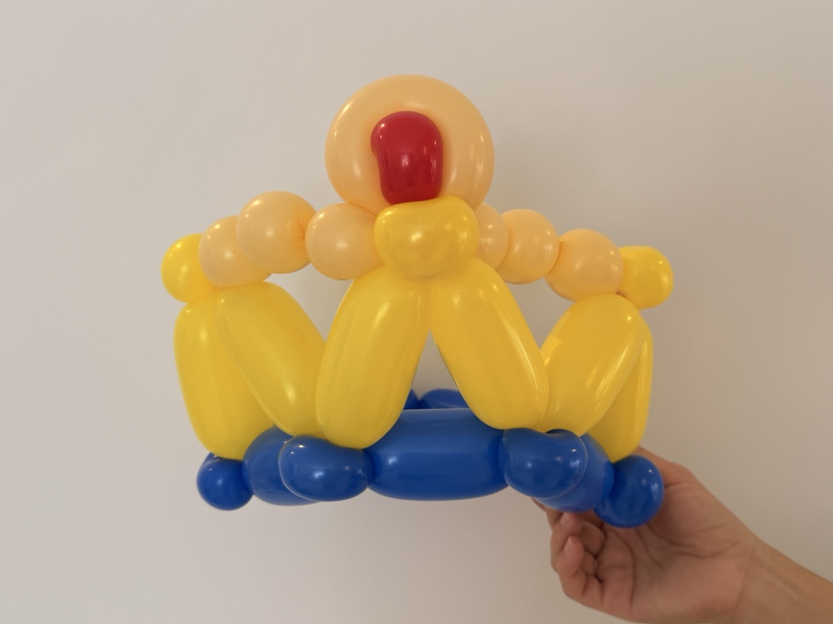 Yellow and blue balloon crown with red jewel