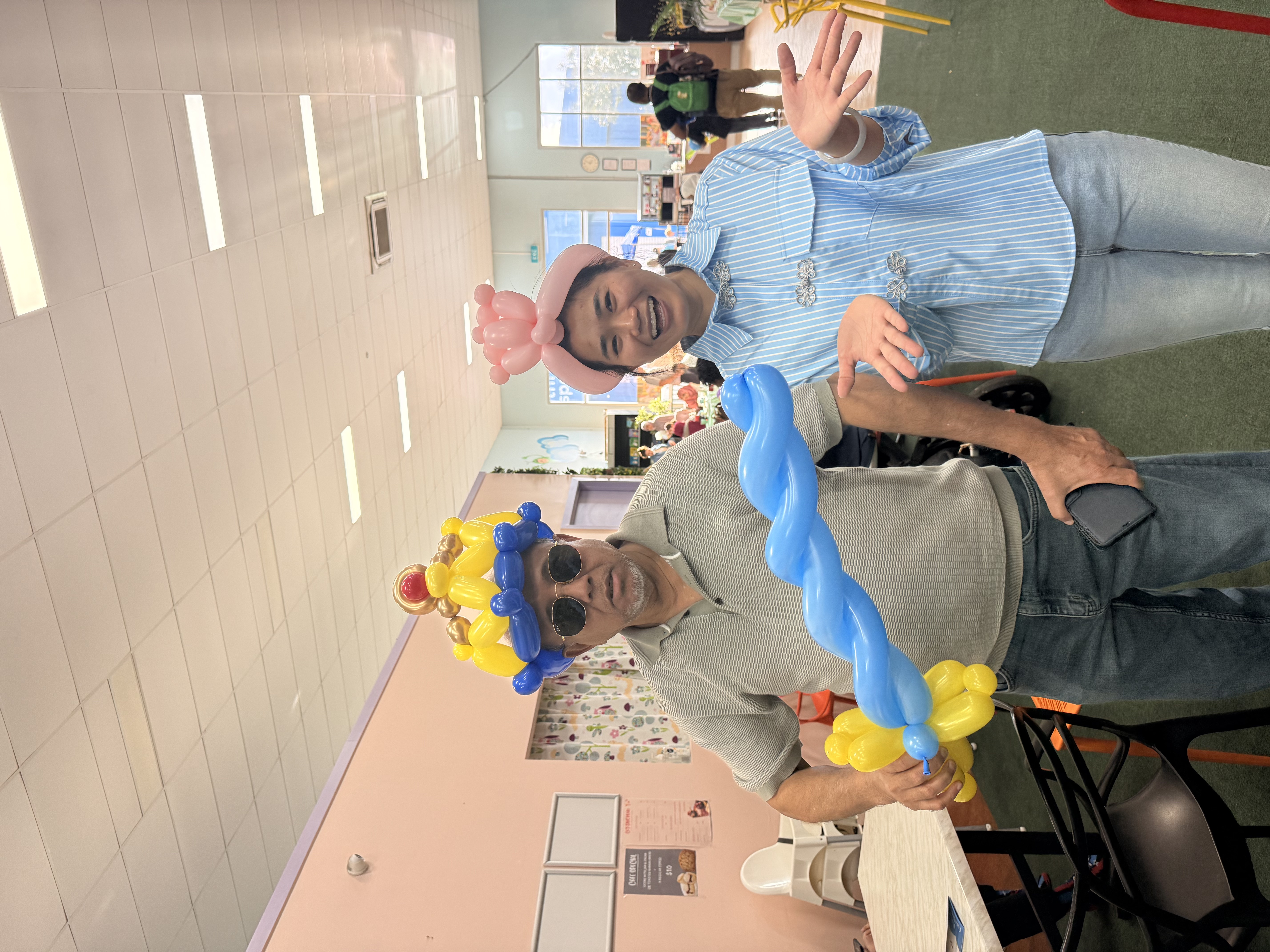 Children wearing QiBear balloon crowns at an event