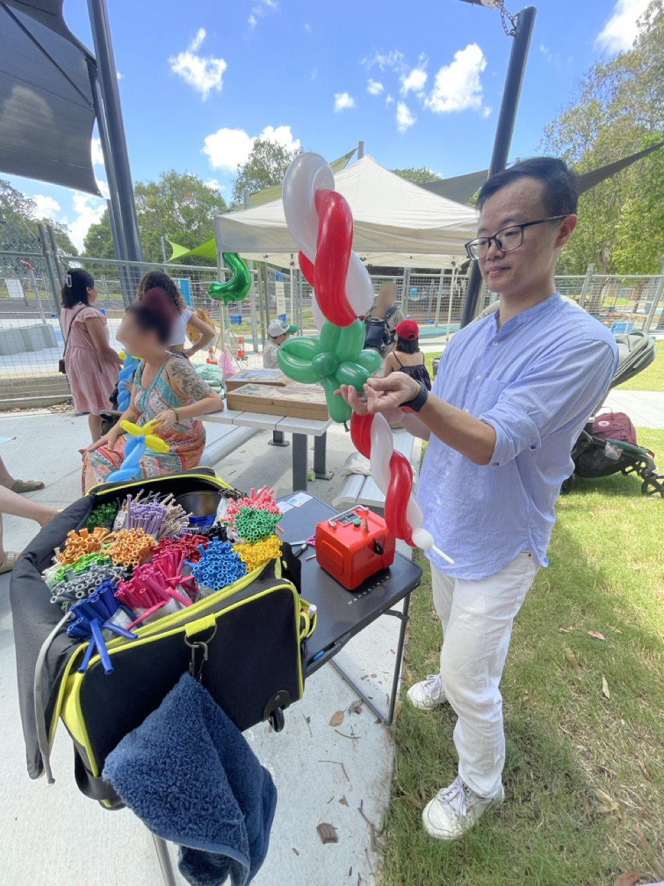 QiBear balloon twisting stall at an outdoor community event in Brisbane